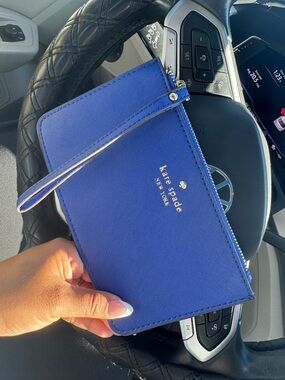 kate spade cobalt blue wristlet clutch with gold logo